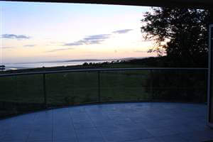 Royal Chrome curved balcony in the evening with beautiful sea view in the distance