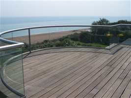 Curved balcony 1 silver balustrade with the view of the beach and the sea with blue sky