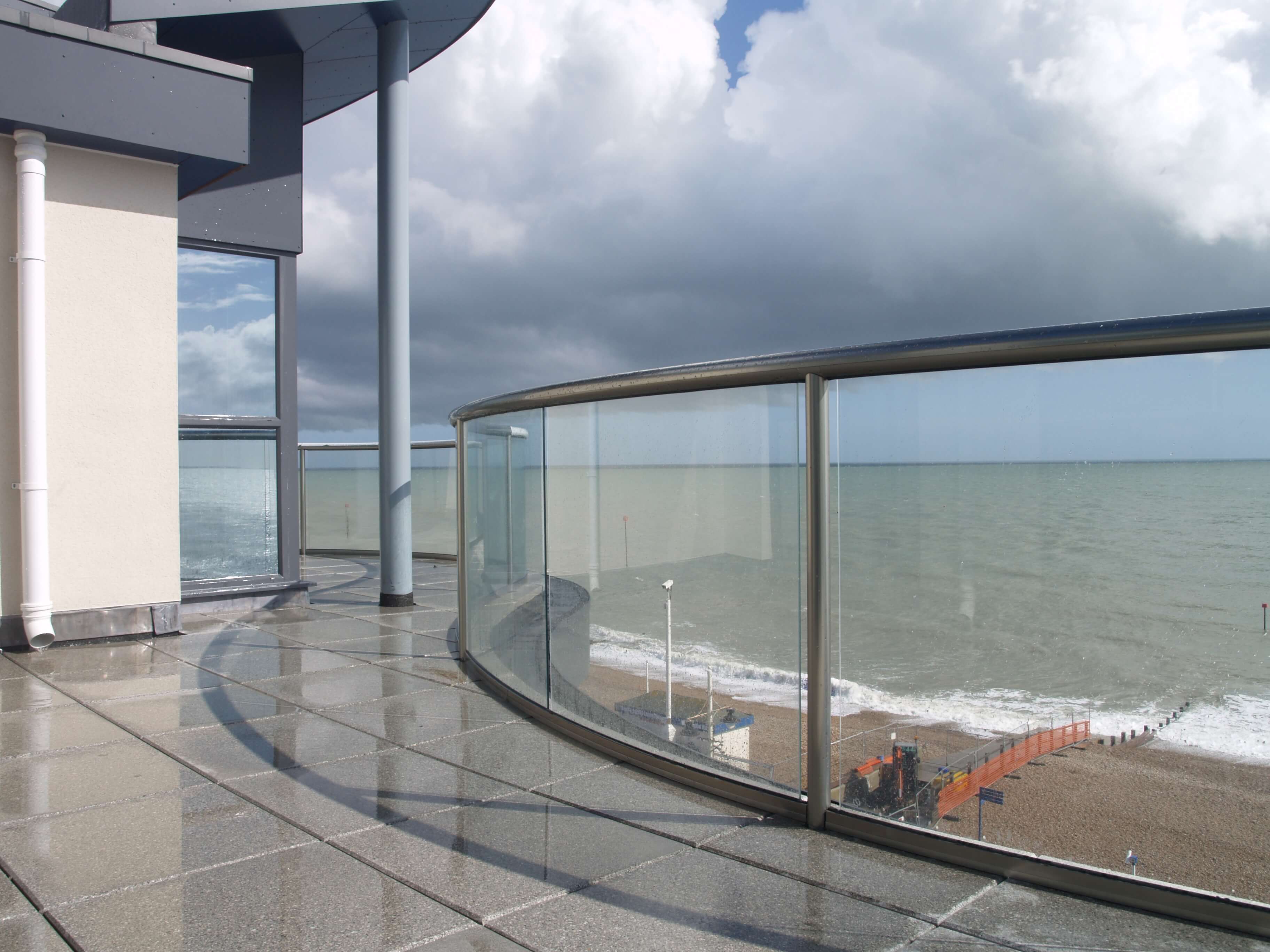Curved glass balustrade on a coastal terrace
