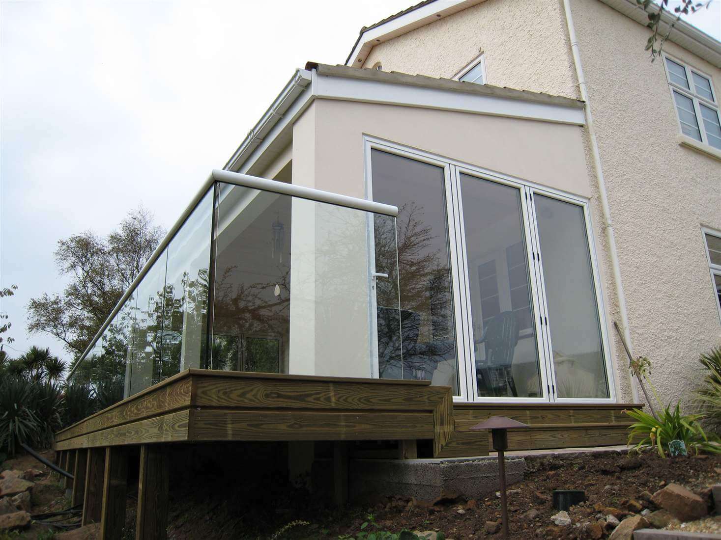 White handrail on semi frameless structural glass balustrade