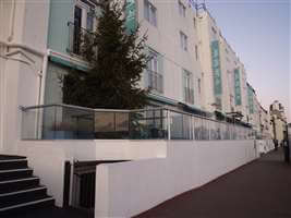 Large restaurant balcony on the seafront with silver handrails