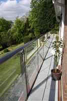 Side view of a long balcony with Royal Chrome handrails and posts