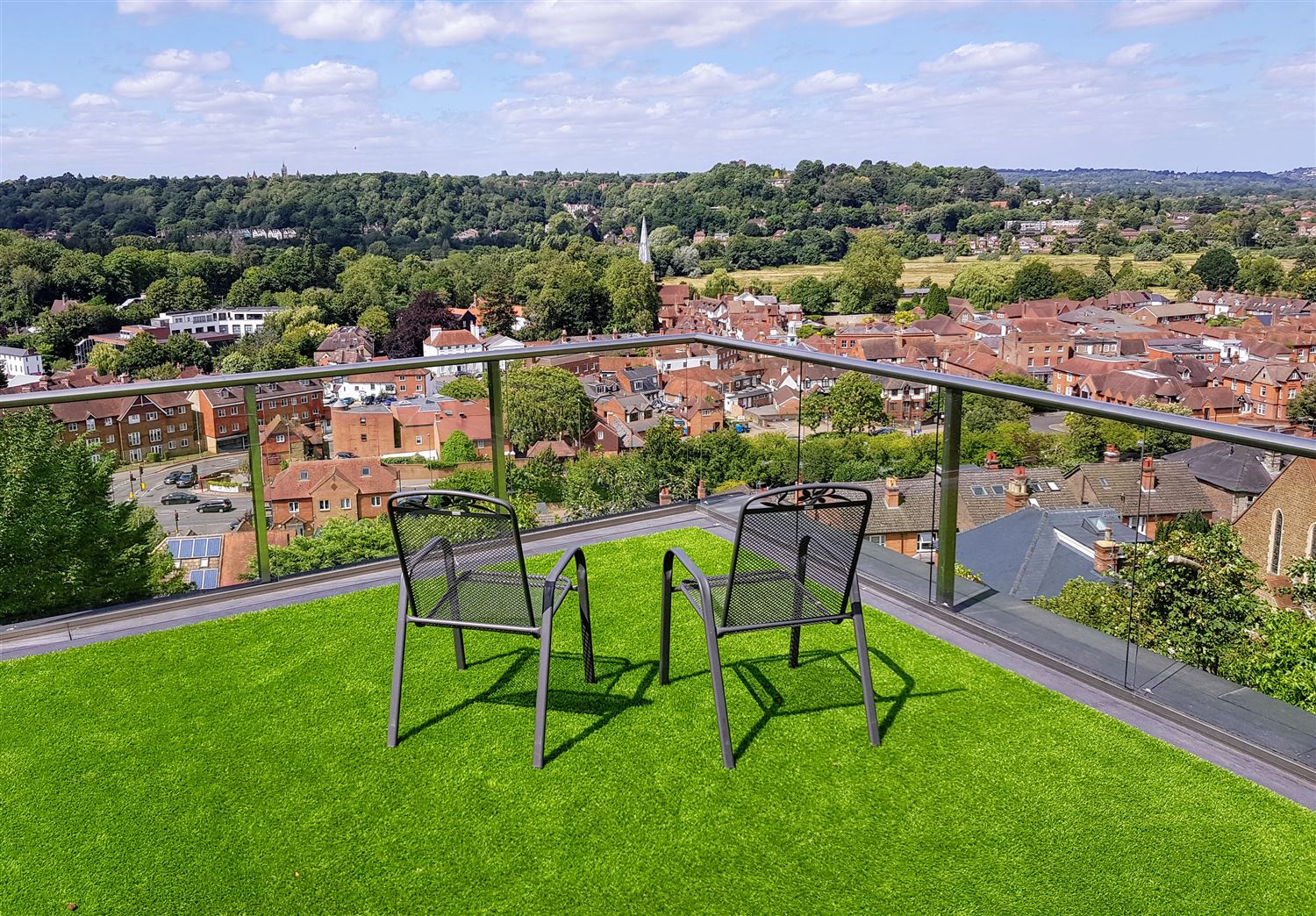 Glass balcony with deck chairs