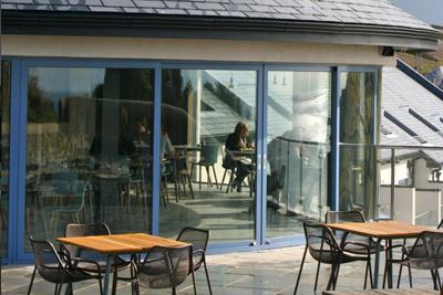 View of the Blue Curved Glass Doors from the terrace at Gara Rock