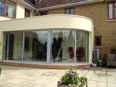 Curved glass door on the right side of a conservatory