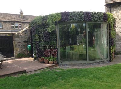 Curved Glass Door installed in a living wall.