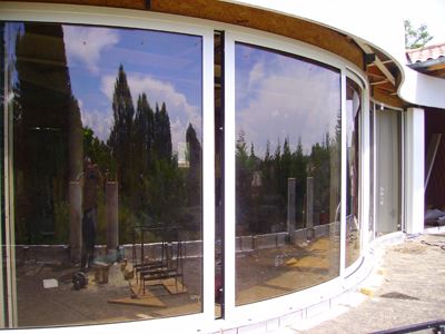 White Curved Glass Doors reflecting the woodland scenary