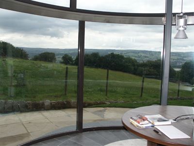 Curved Glass Door with recessed rail looking over countryside