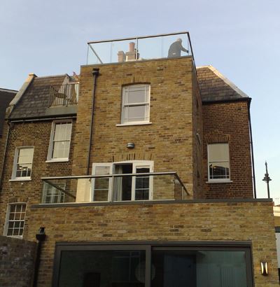 Royal Chrome Orbit Glass Balustrade installed on a square brick property