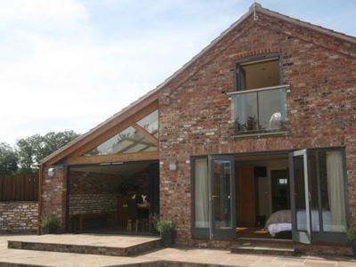 Glass Juliet Balcony installed on an unusual brick house