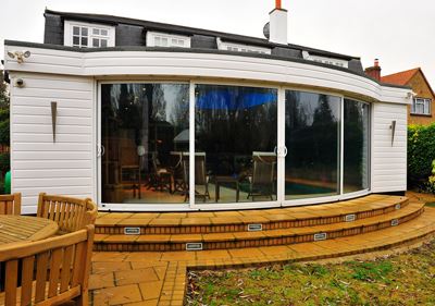 White Curved Glass Sliding Doors installed on the extension at a Hertfordshire home