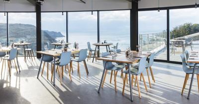 Curved Glass Sliding Doors installed at Gara Rock restaurant looking out onto a stunning view.   