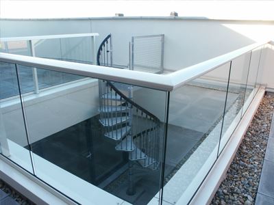 Silver Aerofoil Glass Balustrade leading down to a spiral staircase