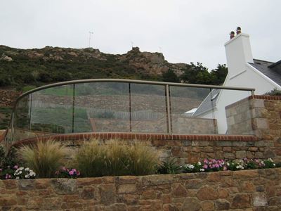 Curved Orbit Bronze Glass Balustrade creating a glass wall