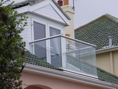 Loft conversion balcony with silver handrail