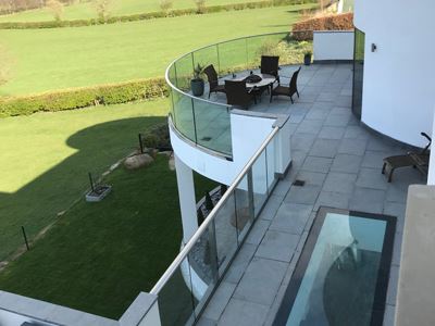  SG12 Frameless Balustrade with handrail overlooking the sunny Yorkshire countryside