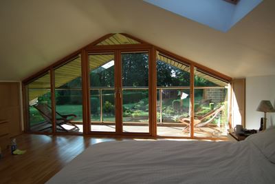 View through a triangle shaped set of patio doors looking onto a Orbit Royal Chrome Glass Balustrade balcony