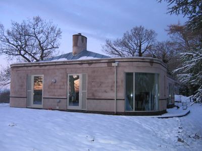 Small building Cured Glass Doors in a snowy environment