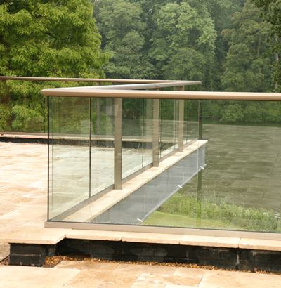 Zigzag Bronze Aerofoil Glass Balustrade overlooking a canopy of trees