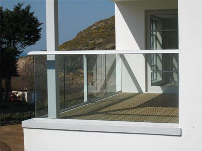 Corner of a white aerofoil handrailed balcony