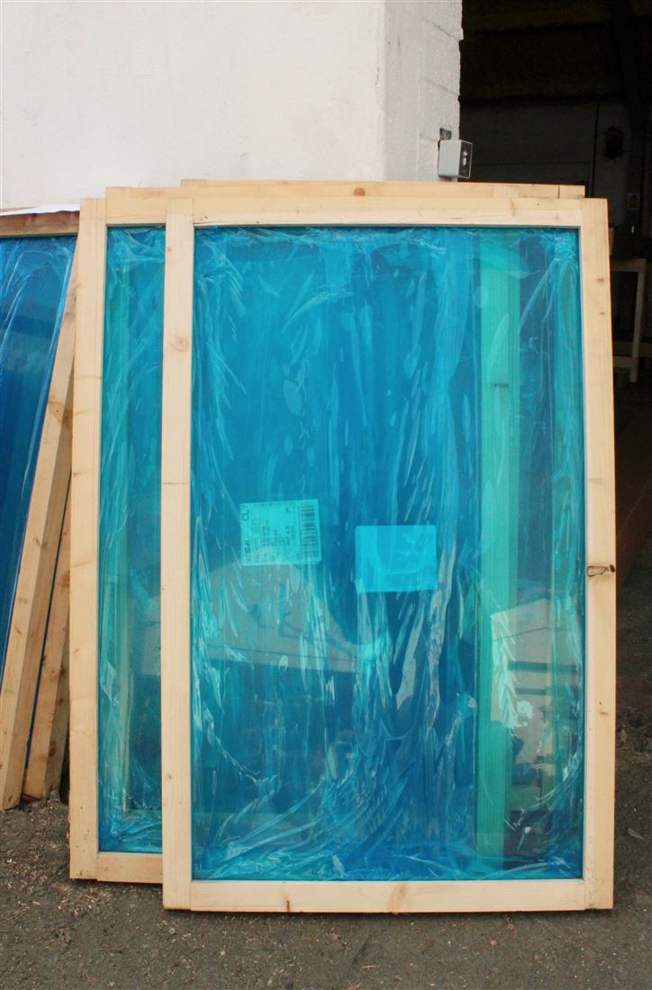 Front view of Balcony glass secured in deep wooden frame ready for delivery