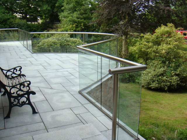 Royal Chrome Orbit Glass Balustrade with curved section overlooking a canal view