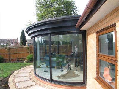 Side view of a curved glass patio door looking onto the garden