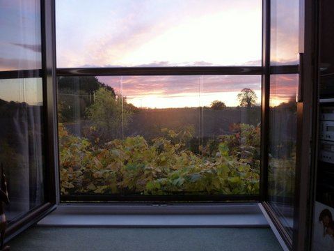 Sunset view through a Royal Chrome Orbit Juliet Balcony 