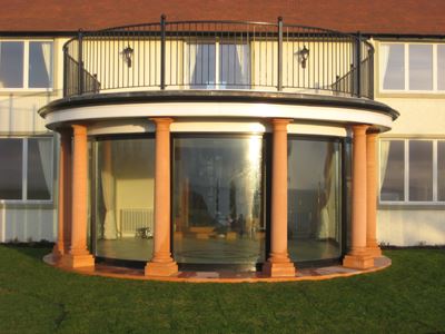 Curved Glass Doors installed in a property with columns