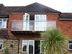 Silver Glass Balustrade installed on a tile hung house