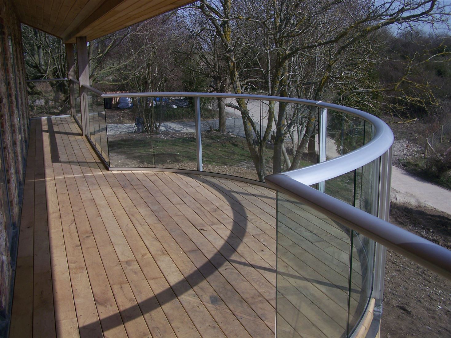 Silver Curved Aerofoil Glass Balustrade with dry land view