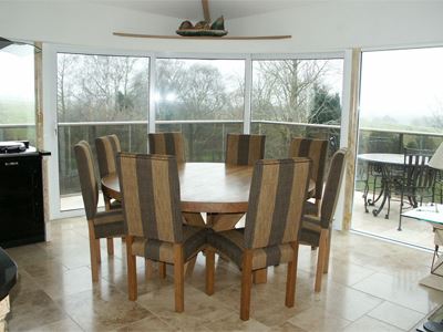 Dining room with curved glass doors overlooking countryside
