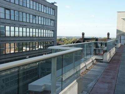 Long Silver Aerofoil Glass Balustrade installed in a city