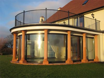 large curved glass doors surrounded in pillars