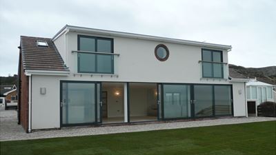 Royal Chrome Juliet Balcony installed on a white house 