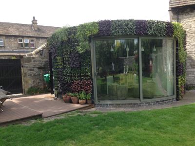 Curved door covered in plants for nature effect