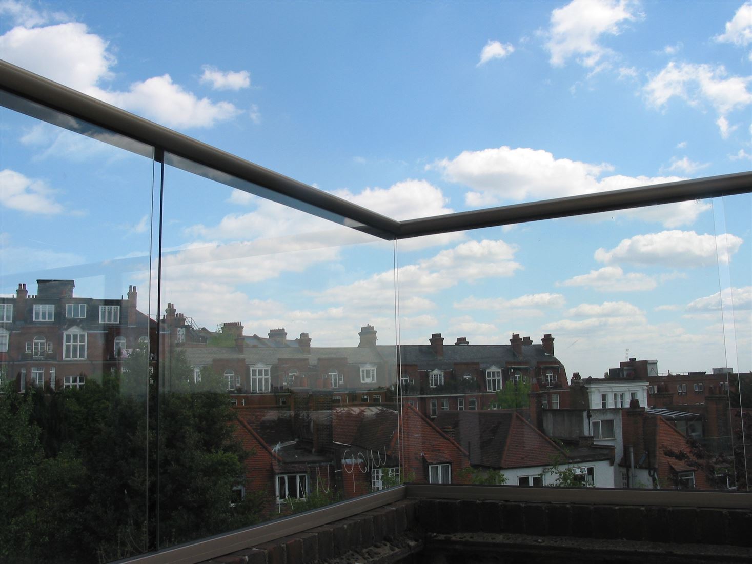 Royal Chrome Aerofoil Glass Balustrade overlooking a clear view of a town