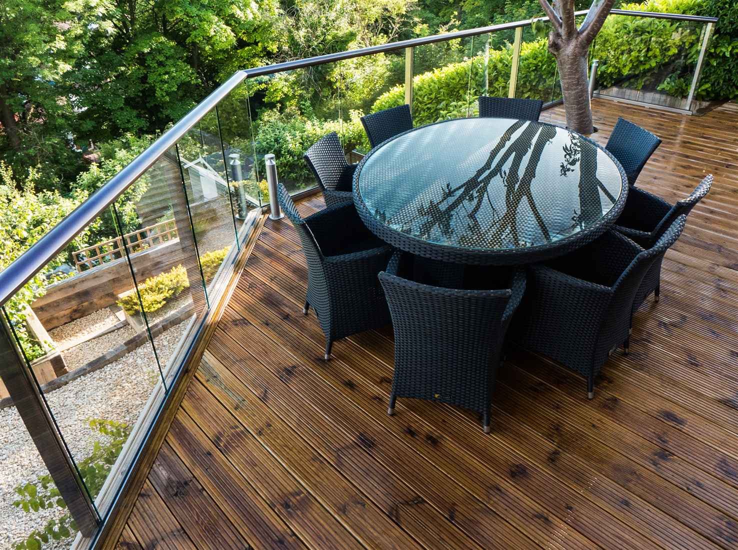 A Royal Chrome Aerofoil Glass Balustrade overlooking a pretty garden in Brighton