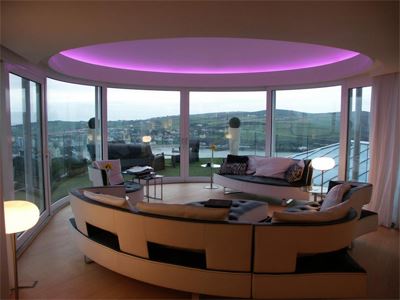 Purple LED lit room looking out onto the countryside