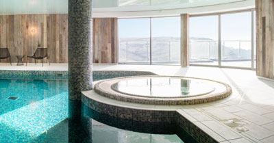 Curved Glass Doors installed in a beautiful pool room